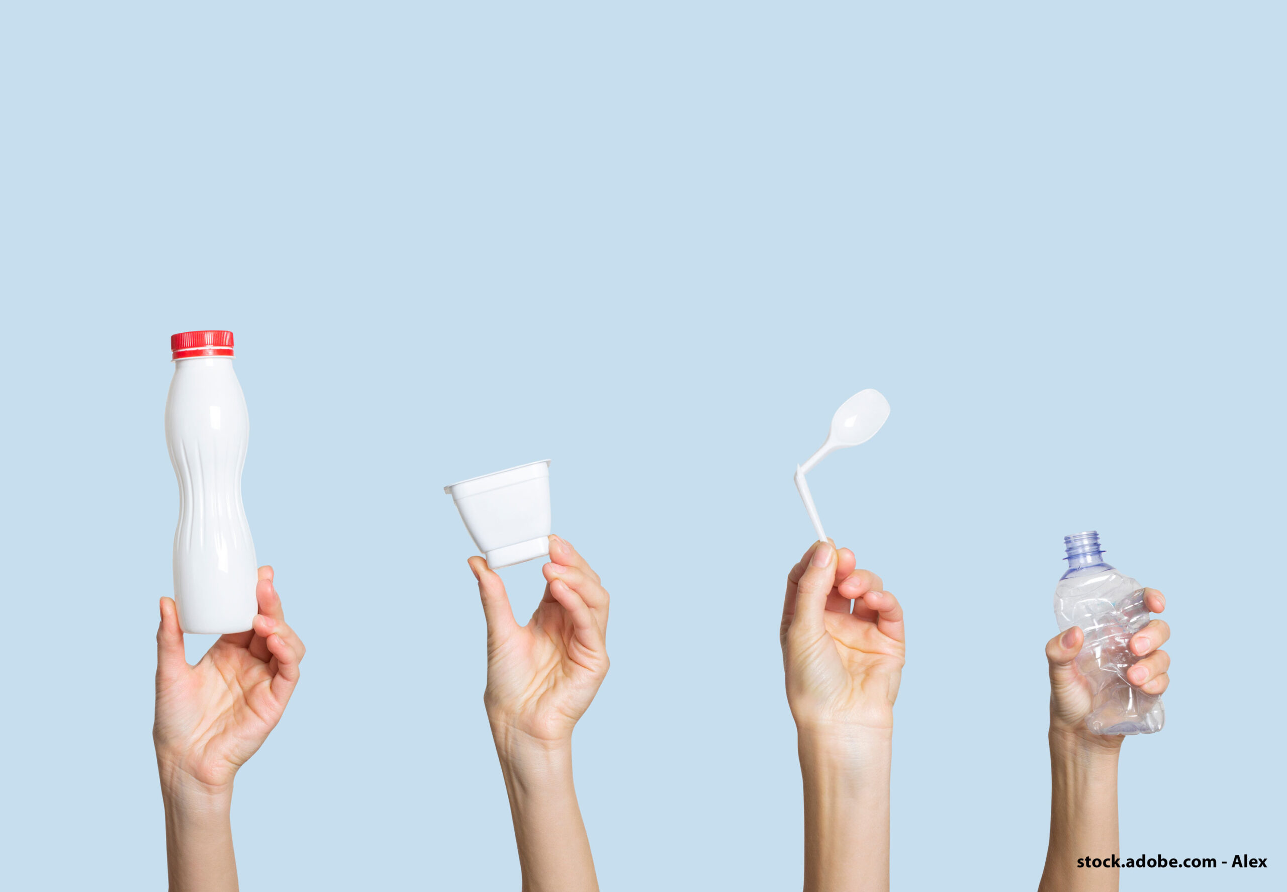 4 hands raised in the air and holding each a plastic item