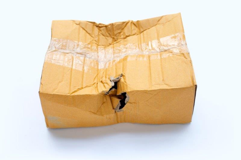 A damaged parcel with a hole at its center