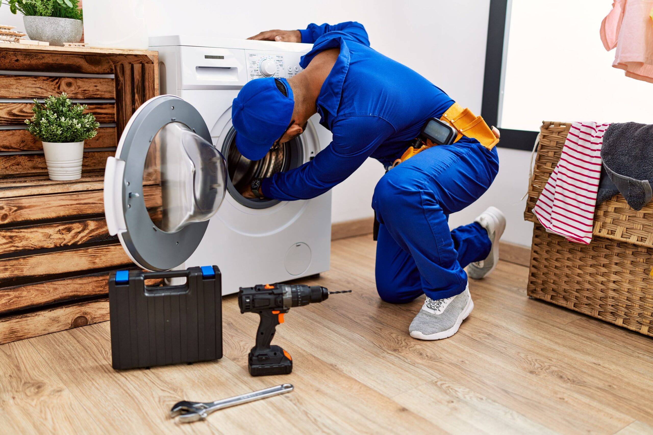 A man repairing a washing machine