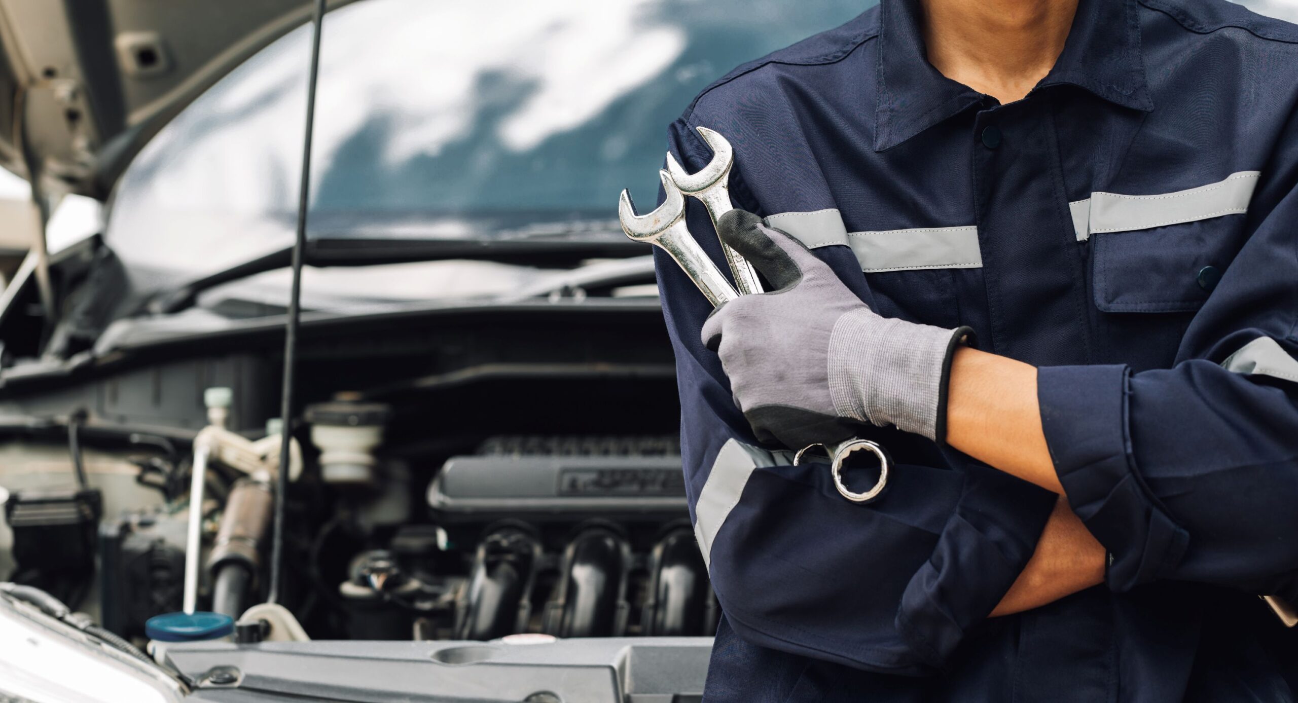 a mechanic with tools in his hands