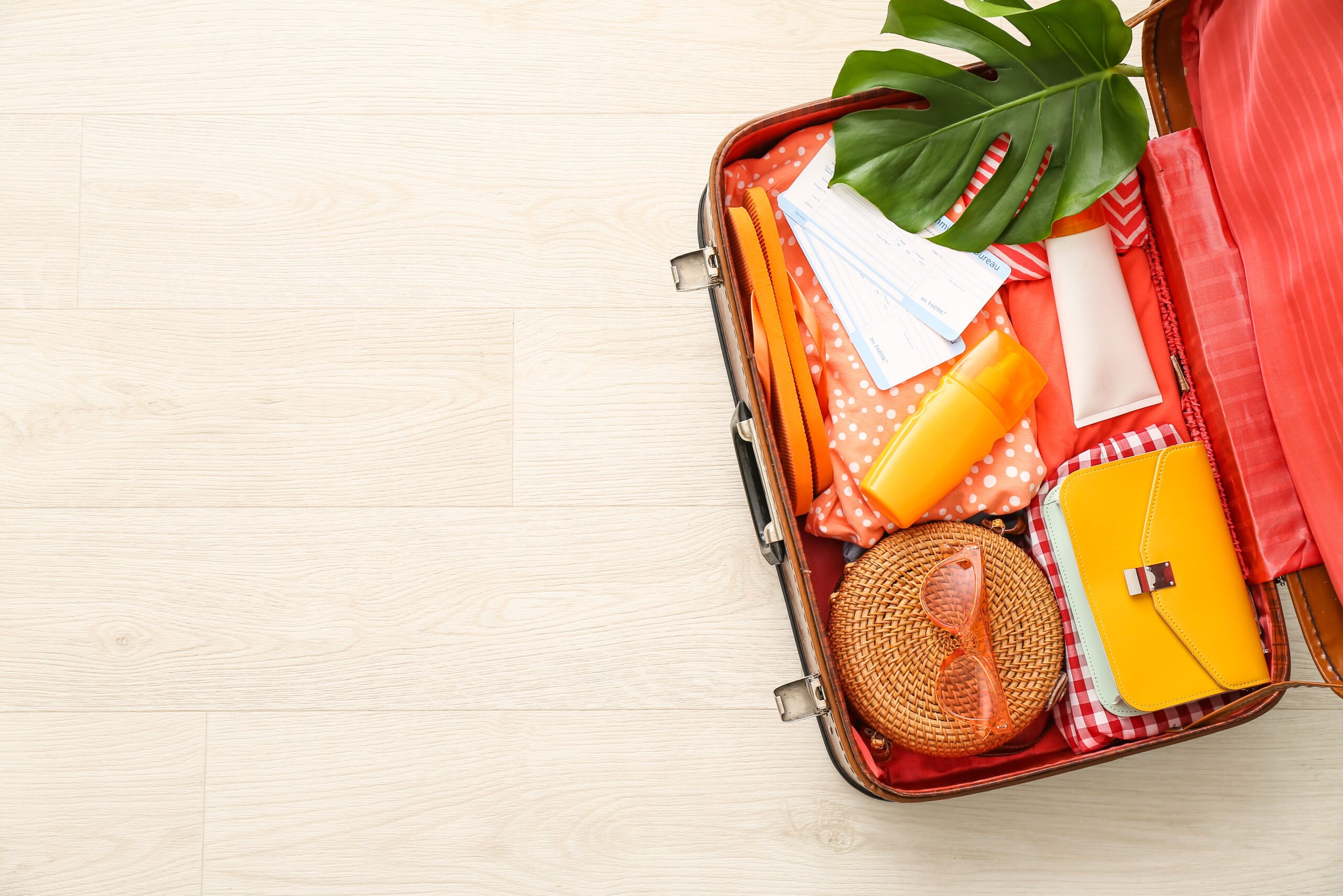 A suitcase that is packed but left open, neatly organised and not overloaded
