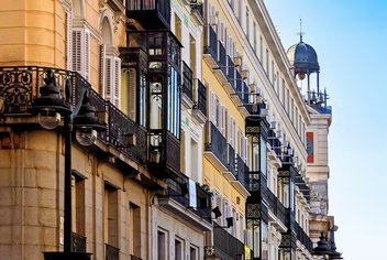 View of a building facade in Spain with windows and balconies.