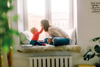 A mother and her child play together.