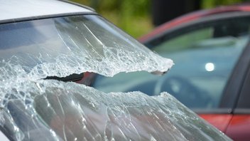 Close-up on the broken windshield of a vehicle.