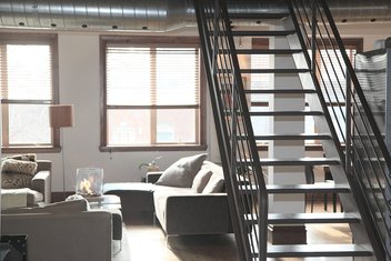 The inside of an apartment with a staircase.