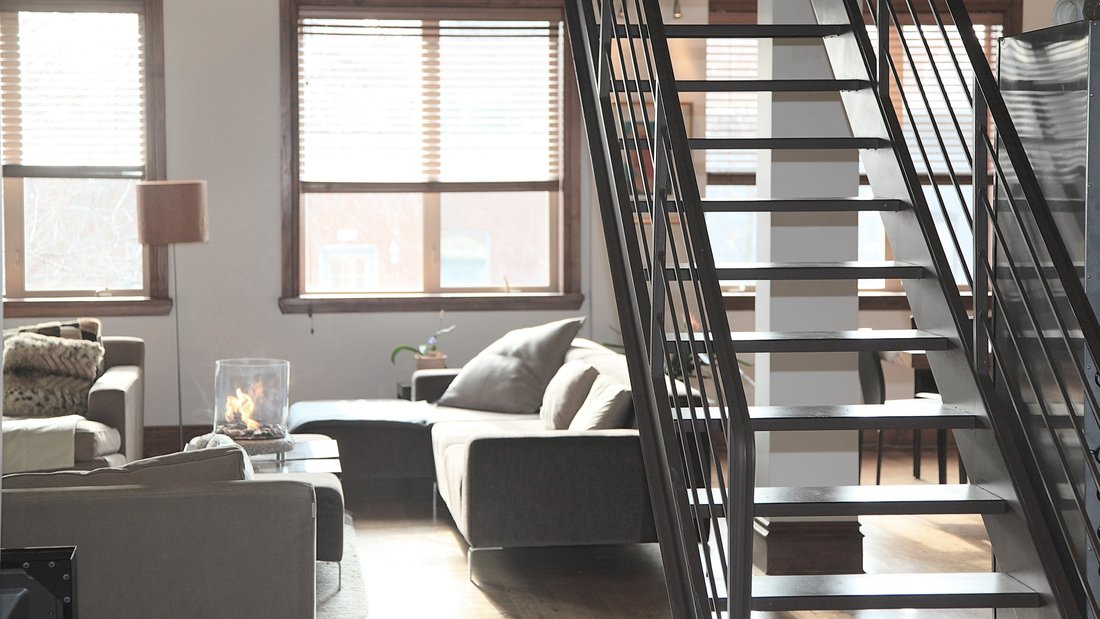 The inside of an apartment with a staircase.